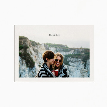 thank you card with an image of a couple embracing on top of a mountain and smiling
