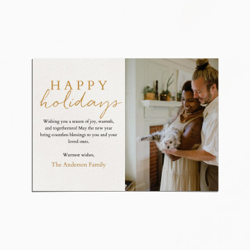 Holiday card with an image of a couple and their cat. The title reads "Happy holidays"