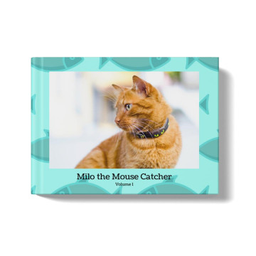 Pets photobook with a teal background and fish pattern. At the center of the cover is an image of an orange cat, and a title beneath the image that says: "Milo the Mouse Catcher, Volume 1"