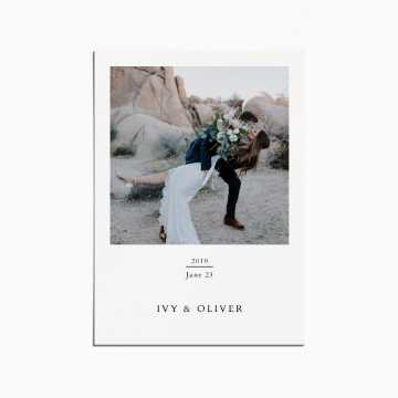 card with an image of a couple on their wedding day, the bride is being dipped. they are in a rocky desert landscape