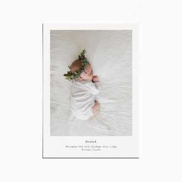 birth announcement card with an image of a baby sleeping and wearing a flower crown