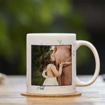 Mug with an image or a pregnant mother and her daughter; her daughter is kissing her belly