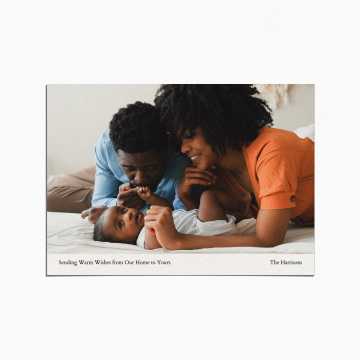 Holiday Card with an image of parents and their newborn baby. The title reads "Sending Warm Wishes from Our Home to Yours"