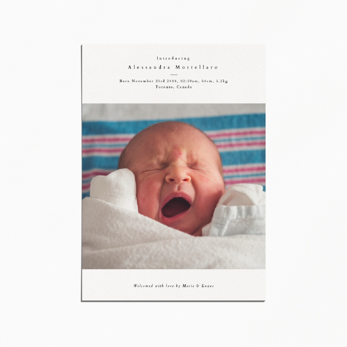 Birth announcement card with an image of a newborn baby yawning