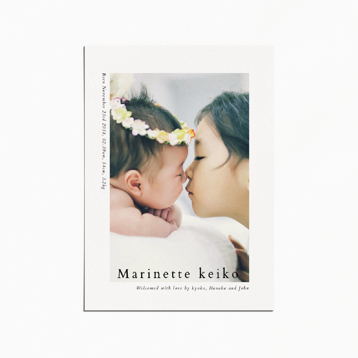 Birth announcement card with an image of a newborn baby and their older sister