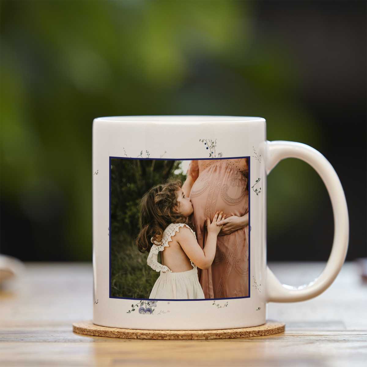 Mug with an image or a pregnant mother and her daughter; her daughter is kissing her belly