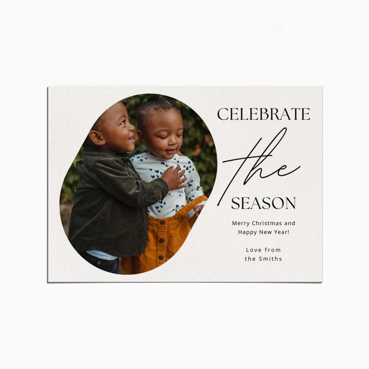 Holiday Card with an image of of two toddlers embracing. The title reads "Celebrate the Season"