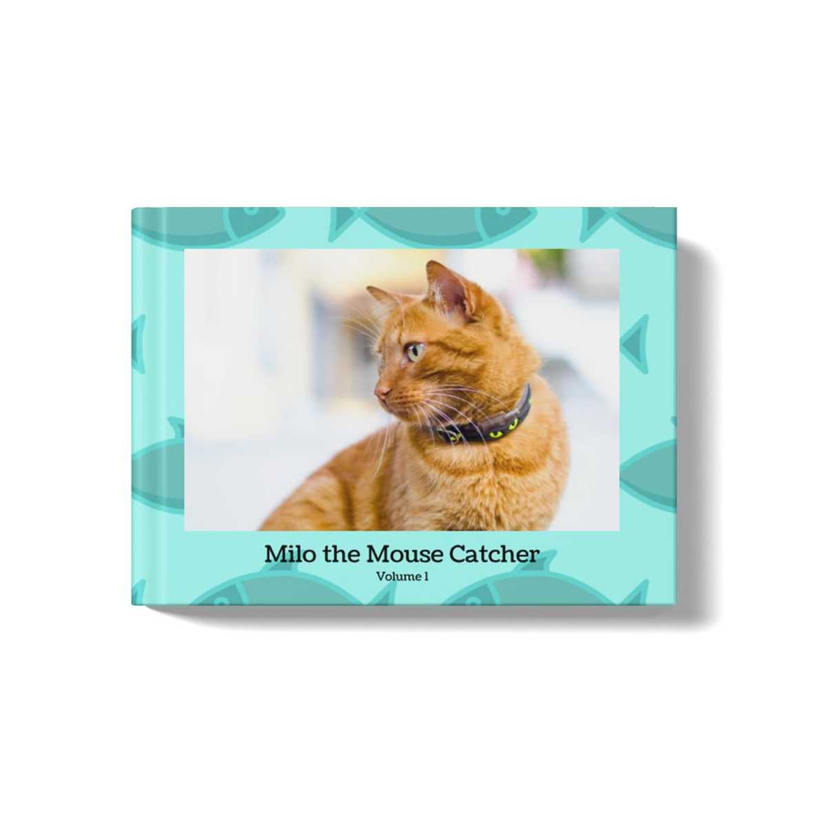 Pets photobook with a teal background and fish pattern. At the center of the cover is an image of an orange cat, and a title beneath the image that says: "Milo the Mouse Catcher, Volume 1"