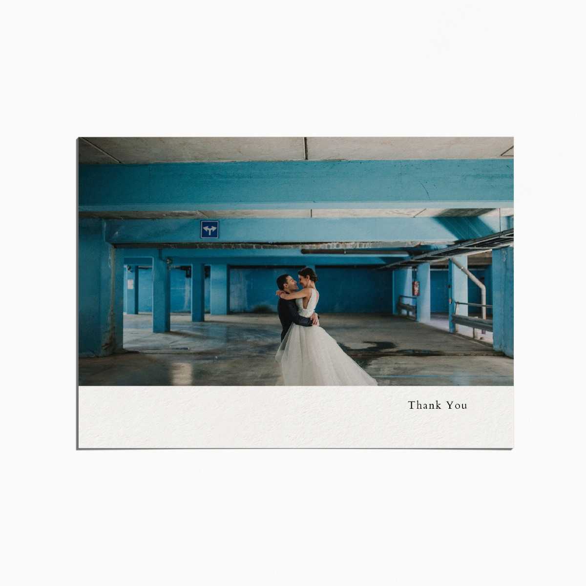 thank you card with an image of a married couple embracing in a parking lot