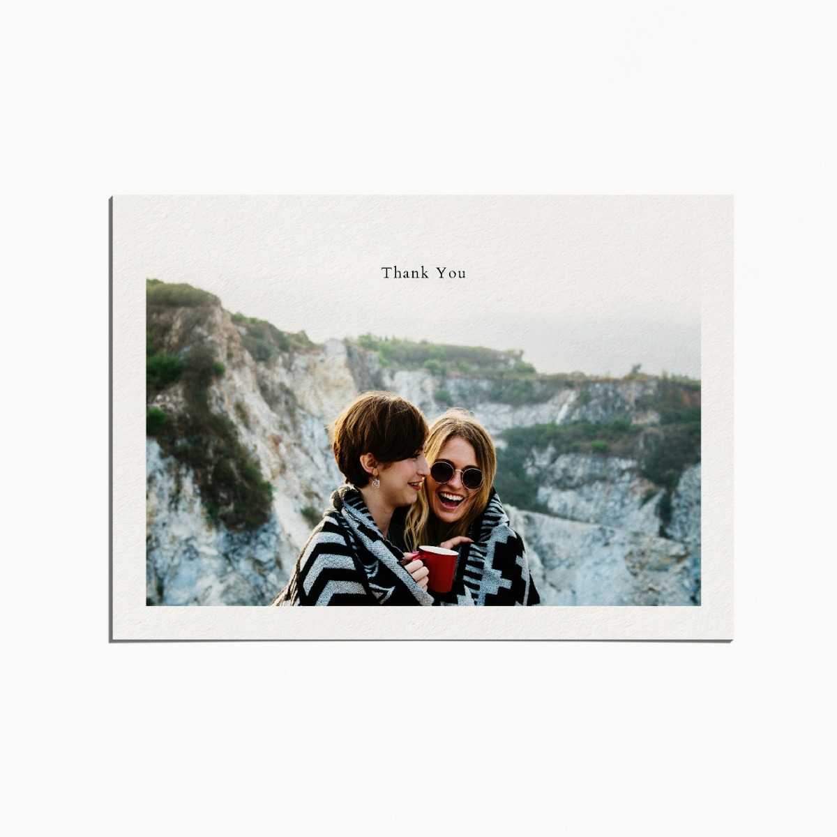 thank you card with an image of a couple embracing on top of a mountain and smiling