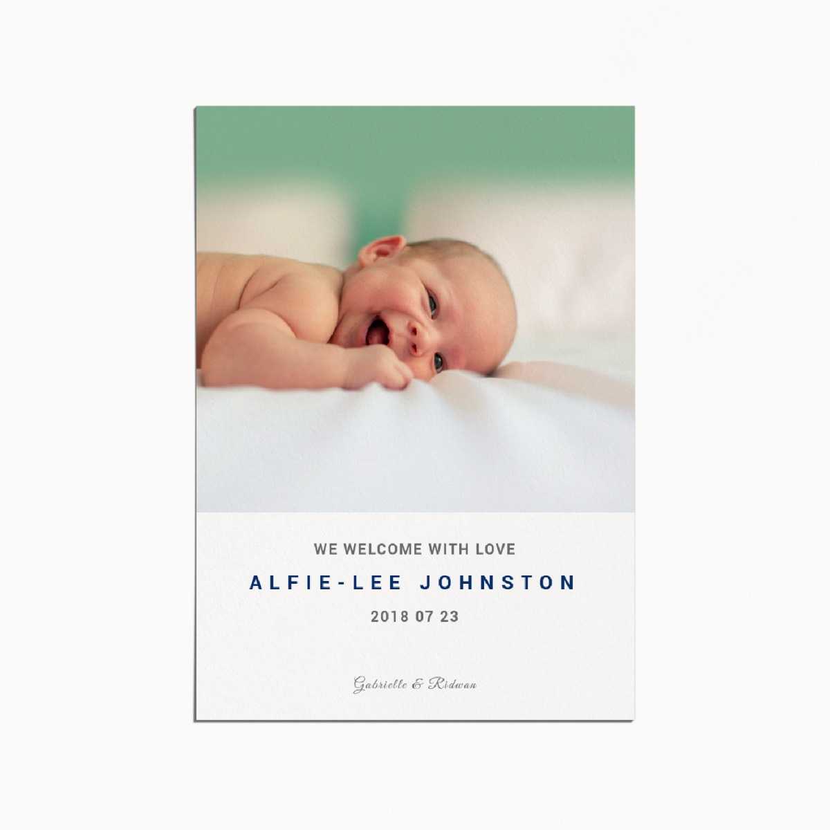 birth announcement card with an image of a smiling baby lying on their belly