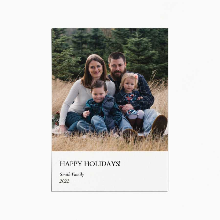 holiday card with an image of a family sitting in a field