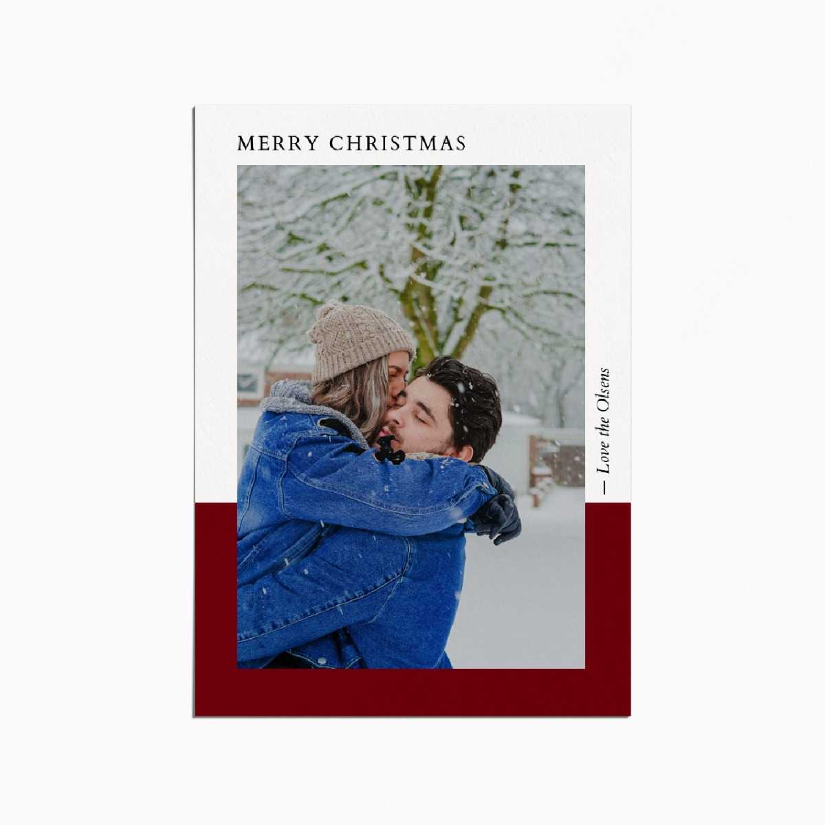 Holiday card with an image of a couple embracing in the snow