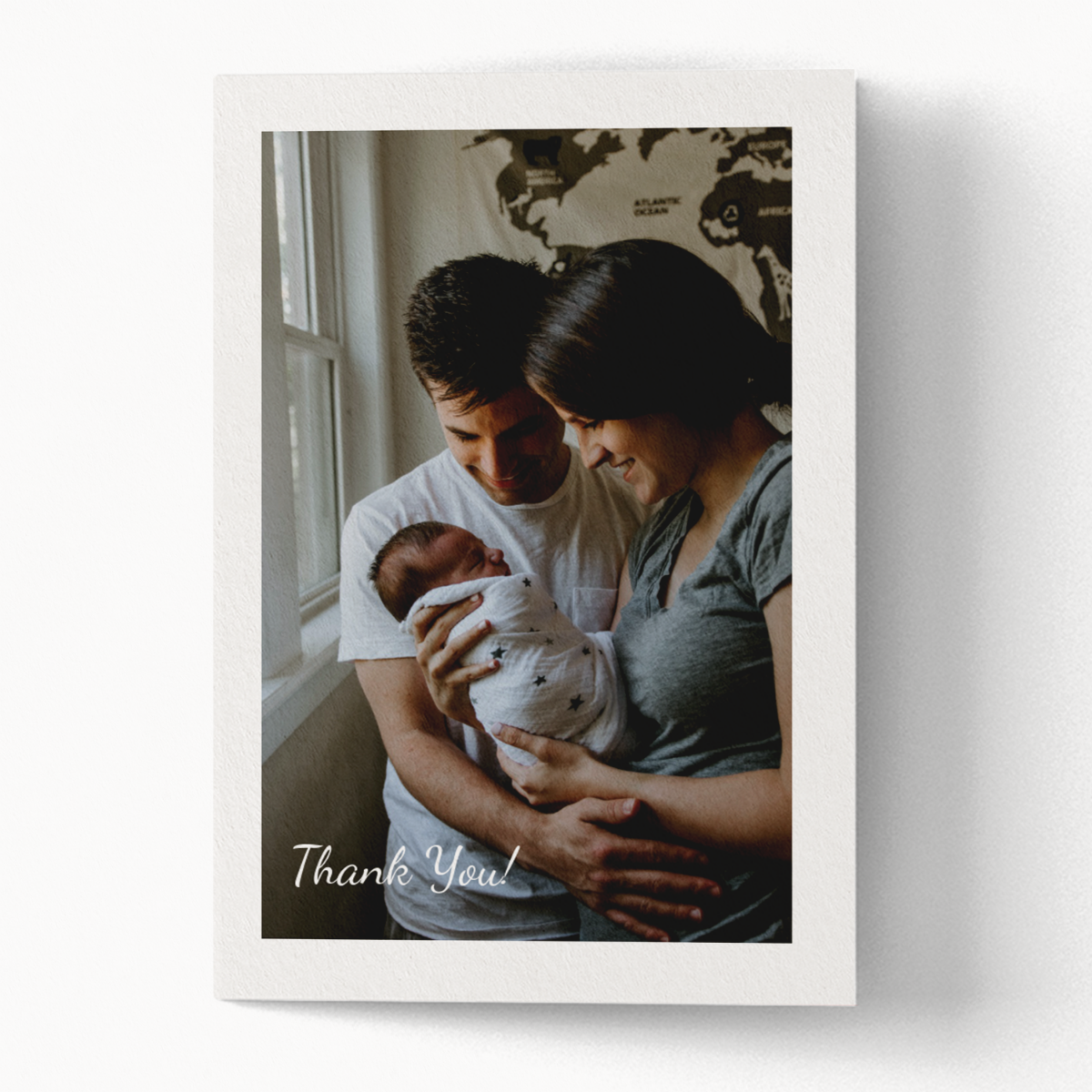 folded thank you card with an image of parents holding their newborn baby