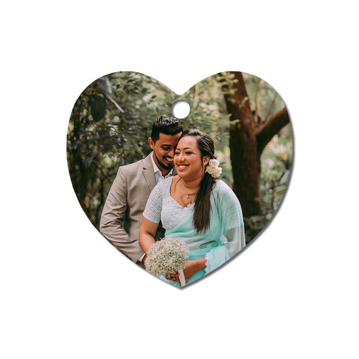 heart-shaped metal ornament with an image of a couple on their wedding day