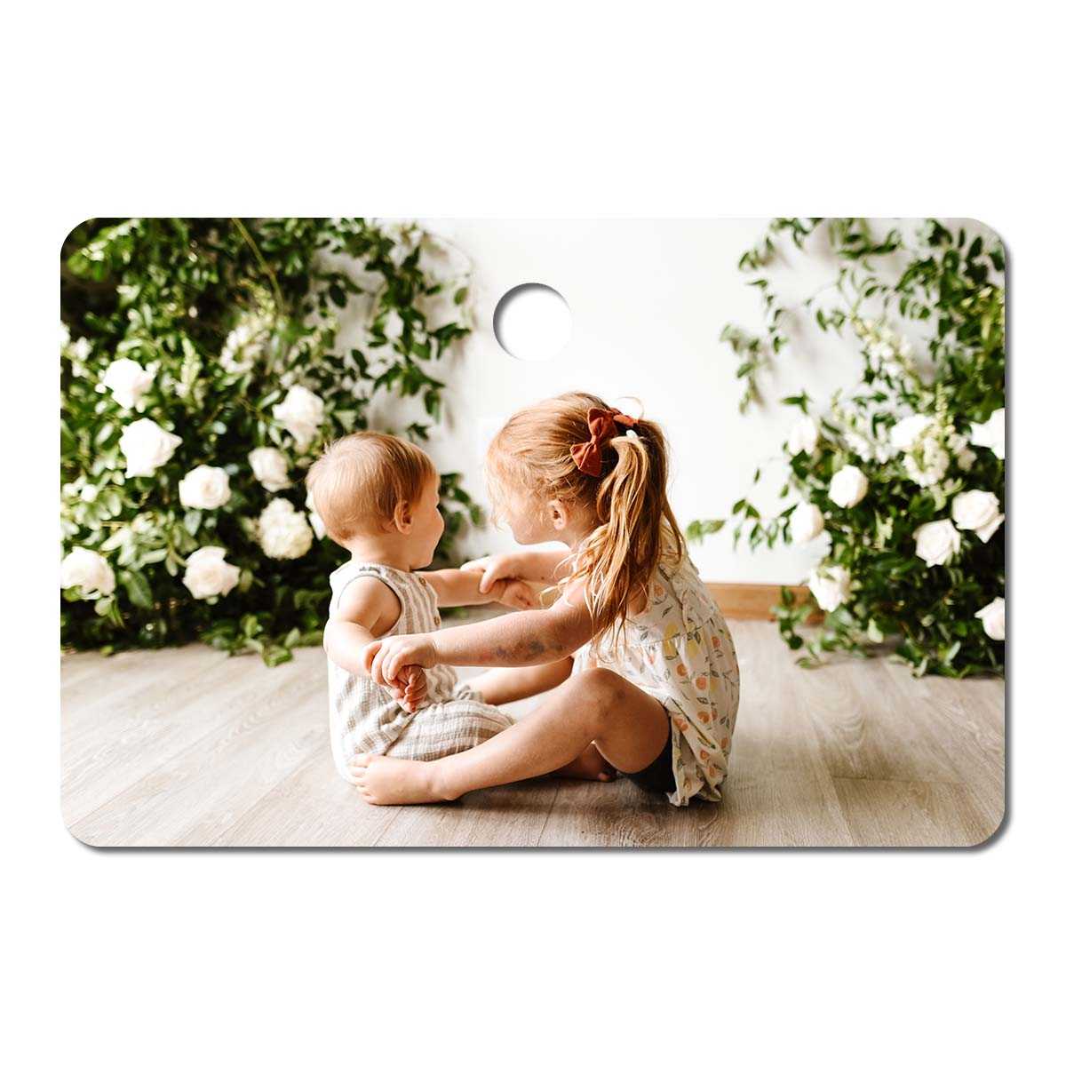 Metal ornament with an image of two small children